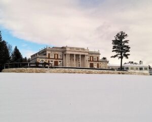 Snowy fields leading up to the majestic facade of Blantyre Castle