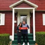 First time homebuyers Rachel and Nick post in front of their new house in Pittsfield sold by Waterfall Perry of Jan Perry Realty Associates