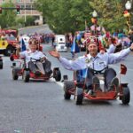 Fall Foliage Parade 2021 Man riding in go cart for the North Berkshire Fall Foliage Parade, followed by a long line of other shriners