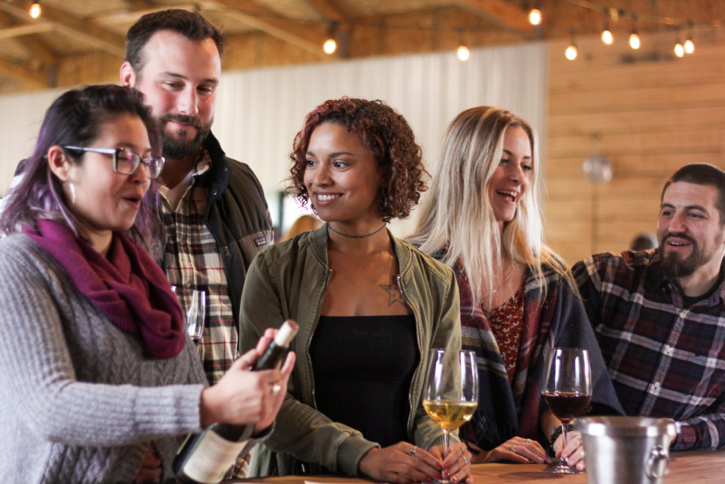 Friends at Balderdash Cellars - photo by kacey Hatch Friends at Balderdash Cellars enjoying glasses of wine, smiling and happy
