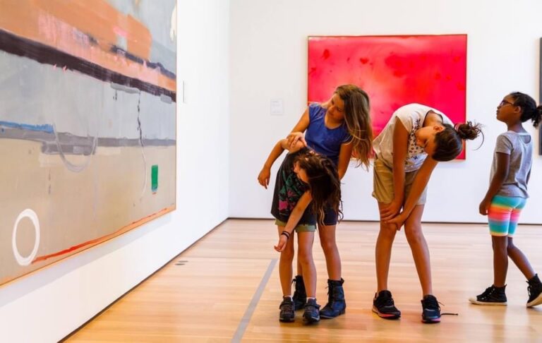 A group of children look at art at The Clark upside down, for a new angle.