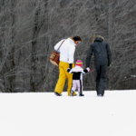 Family walking through snow