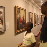 Man and child looking at art at the Norman Rockwell Museum