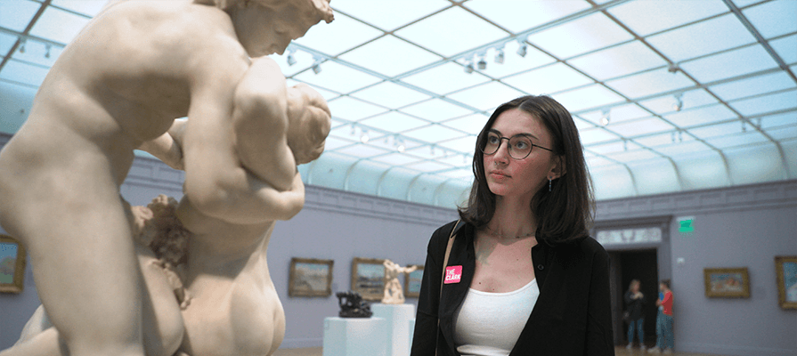 A woman stands in the gallery at The Clark Art gazing at a sculpture