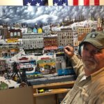 Artist Richard Haskins paints at his easel