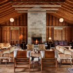 Indoor lodge at Tourists with wood features, cozy seating, and a large brick fireplace