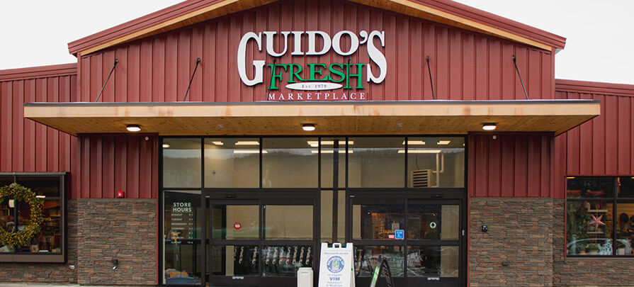 Outside Guido's Fresh Marketplace looking at the front of the store from the parking lot