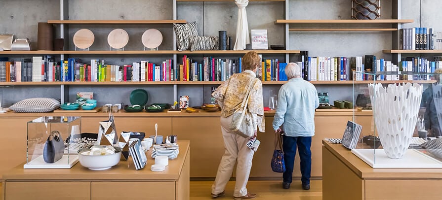 Two people browse the shelves at the Clark Art Gift Shop