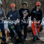 women suited in protective gear learning to use chainsaws