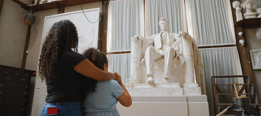 A mother and child gaze at the Lincoln statue in the Chesterwood studio. 