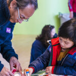 A man and child work on crafts in the MASS MoCA Kidspace