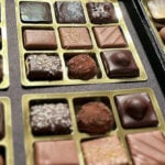 A row of boxes display an assortment of designer chocolates.