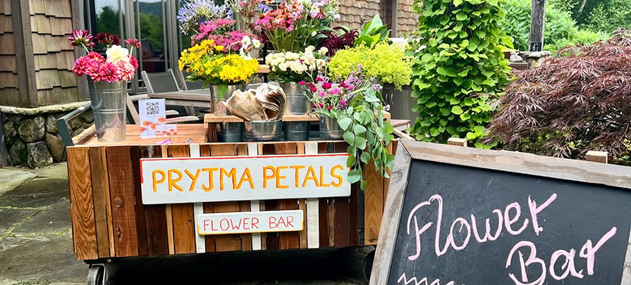 A flower bar stands full with colorful blooms ready to be made into bouquets.