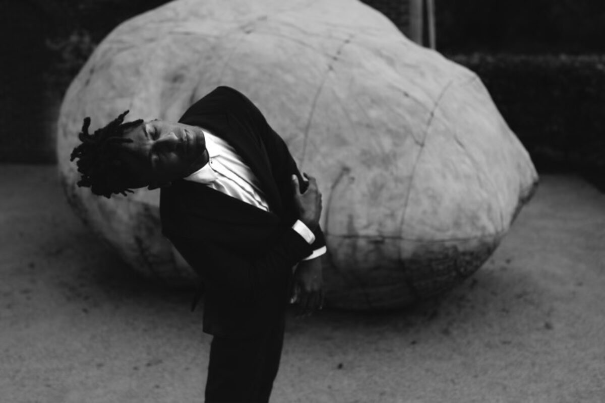 A black and white image of Jon Batiste, who is set to perform at Tanglewood in June