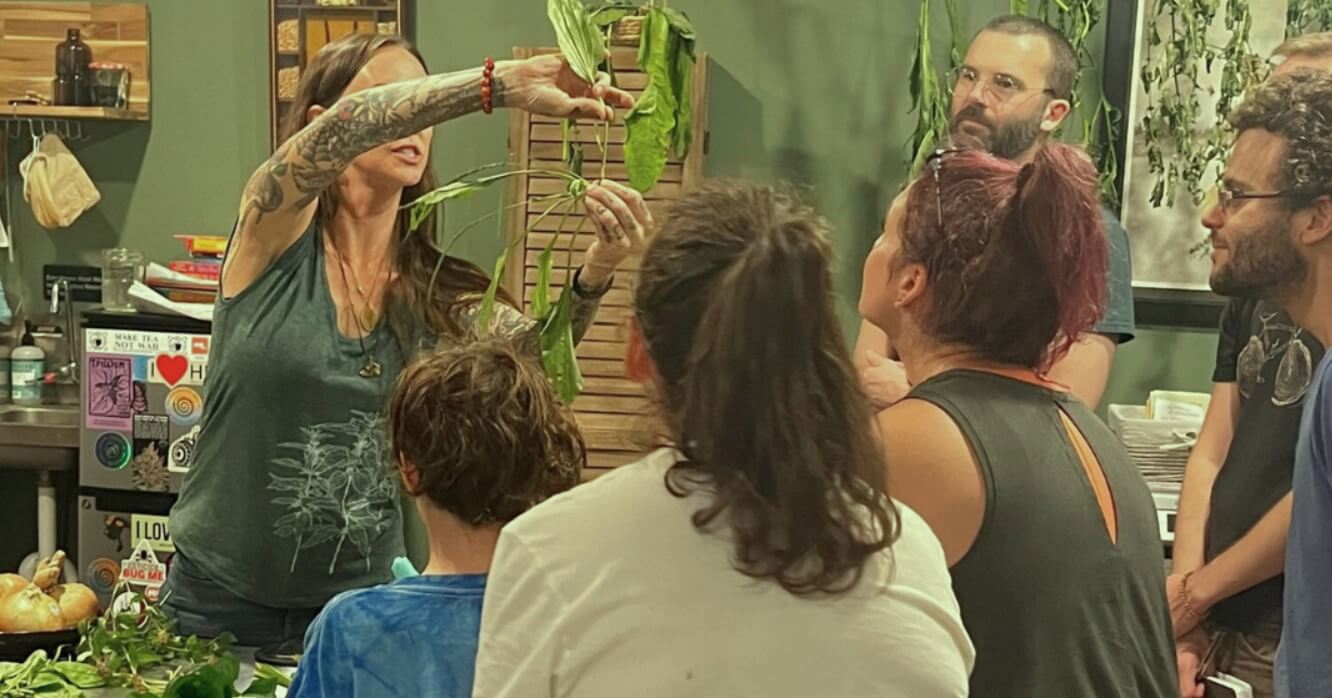 Artist teaches a class in herbal medicine to a group