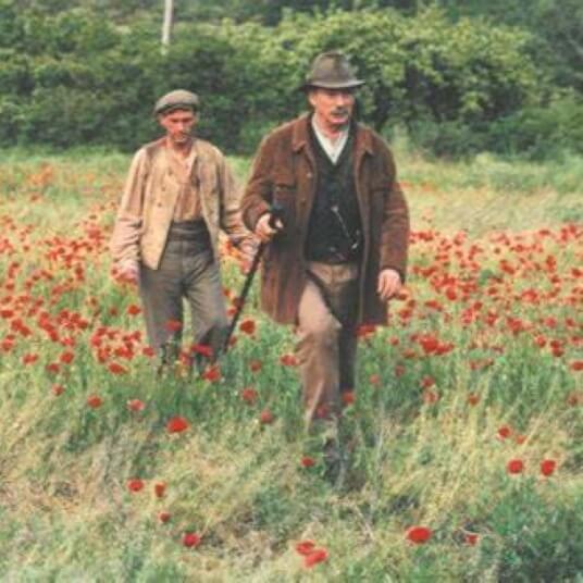 Two men in a field of poppies