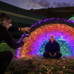 Rainbow colored lights are visible in this art installation in North Adams