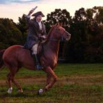 Image of Paul Revere riding his horse with a message.