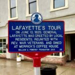 A metal sign engraved with LaFayette's Tour and information on the hisoty.