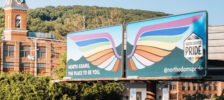 A Pride billboard is featured across the Berkshire Mountain landscape.