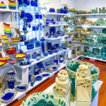 Blue, green, white and multi-colored pottery on display in the showroom of Hoffman Pottery, West Stockbridge, Berkshire County, Massachusetts, USA - April 22, 2025. Owner Elaine Hoffman works on a potter's wheel as well as hand builds with slabs of clay and hand rolled coils braided and woven to create colorful asymmetrical works.