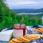 A picnic spread is laid out on a blanket overlooking a beautiful Berkshire landscape.