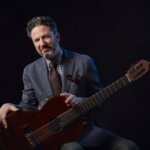 John Pizzarelli poses with his guitar
