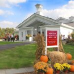 The norman rockwell museum is prominently featured with the red sign and fall decor