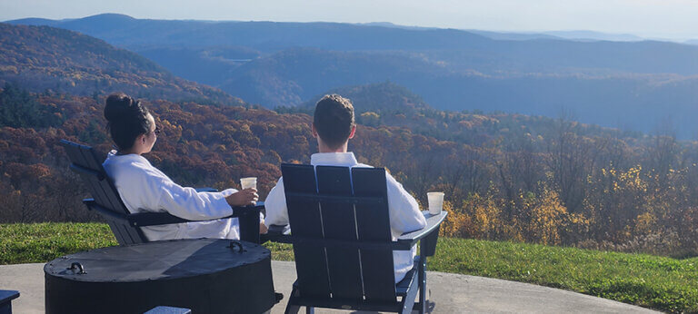 coffee and a view _Blue Vista Motor Lodge_lodging_ places to stay fall vista mountains (2) 895×400 a couple looks out over the foliage covered mountain at Blue Vista Motor Lodge