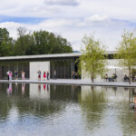 Groups of people gather around the reflection pool at The Clark in summer