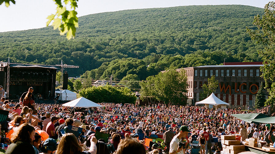 A large crowd enjoys music playing at Solid Sound Festival at MASS MoCA in the summer