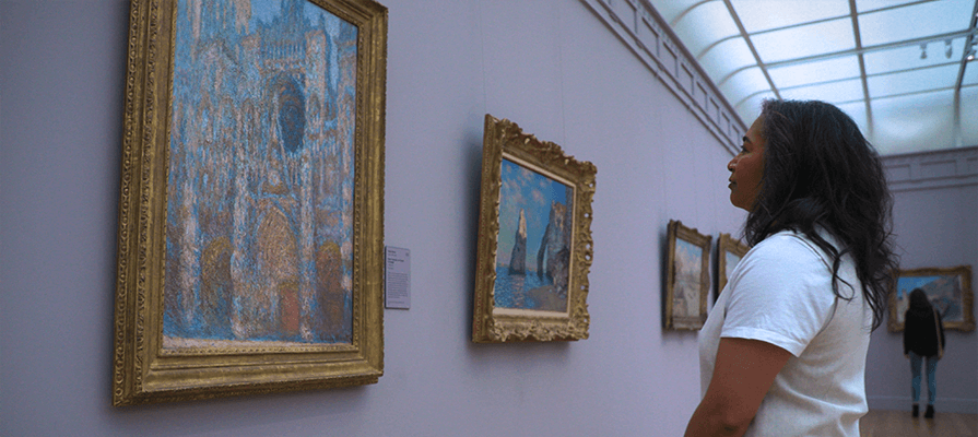 A woman gazes at art at Clark Art Institute