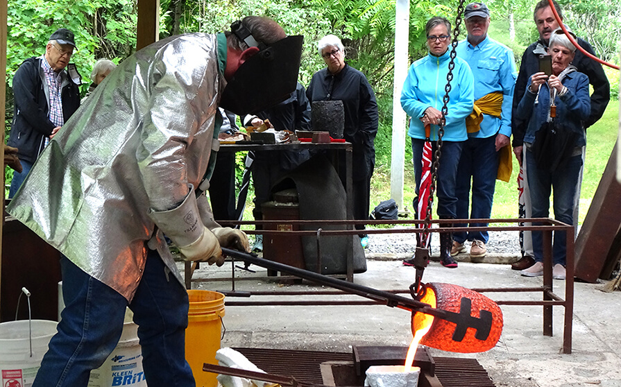 An artist pours hot bronze into a cast as part of ArtWeek Berkshries