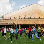 Dancers line up across the lawn of Jacob's Pillow and the Doris Duke Theater.