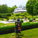 People wander the gardens at The Mount on a sunny summer day.