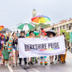 A group from Berkshire Pride hold a banner and march down North Street in Pittsfield wearing rainbow in support of Pride Month